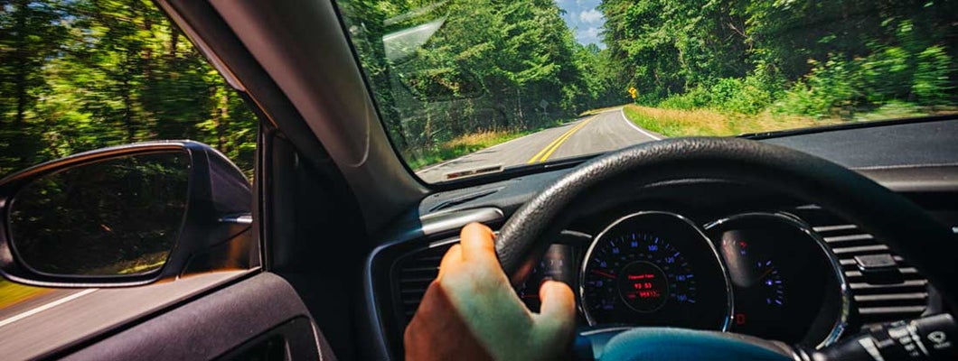 Driver's perspective on a road trip through a country road. Find Bowling Green Kentucky car insurance.