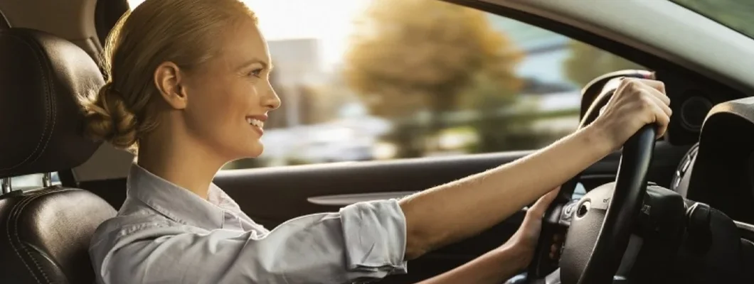 Smiling young businesswoman driving car. Car Insurance in Snoqualmie, Washington.