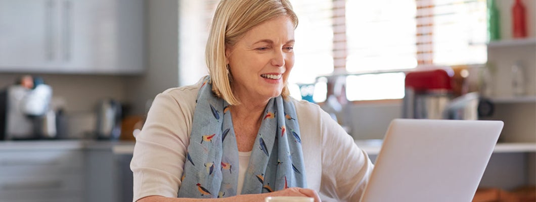 Woman using a laptop computer at home. Find Fixed Annuity Rates.