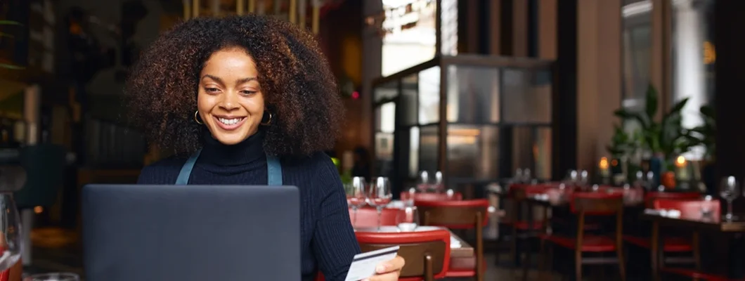 Portrait of restaurant owner using laptop. Business Insurance in Peachtree City, Georgia.
