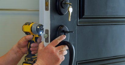 Professional locksmith installing a new deadbolt lock. Ways your home insurance is draining your savings.