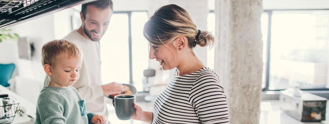 Young family preparing breakfast together in their kitchen. Find New Jersey Life Insurance.