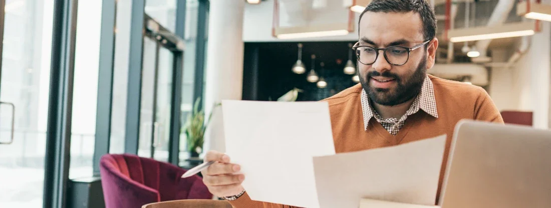 Man reviewing paperwork. Find Accounts Receivable Insurance.