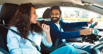 Couple driving car and talking. Is Insurance for an Old Car Necessary?