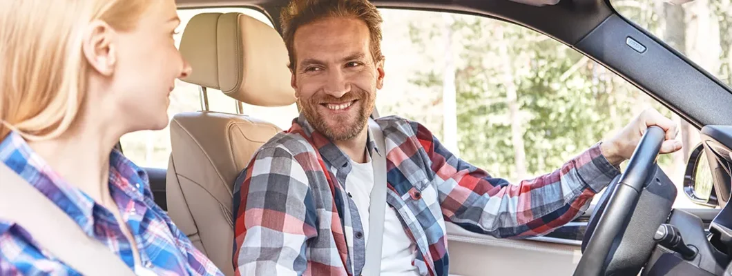 Couple together in car and looking at each other. How to Find the Best Car Insurance in Bozeman, Montana.