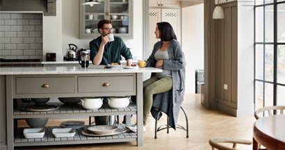Young couple having breakfast together at new home