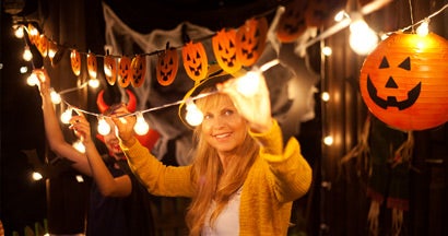 Mom and daughter decorate for Halloween. Safety Tips for Halloween.