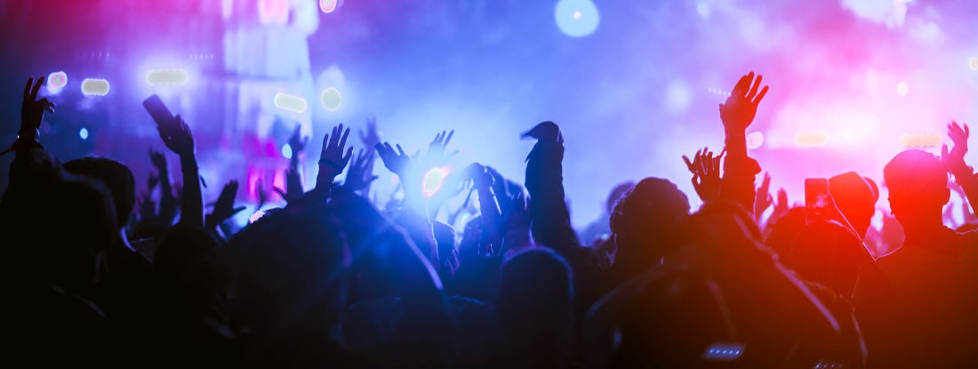 Silhouettes of hand in concert.Light from the stage. Find Nightclub Insurance.