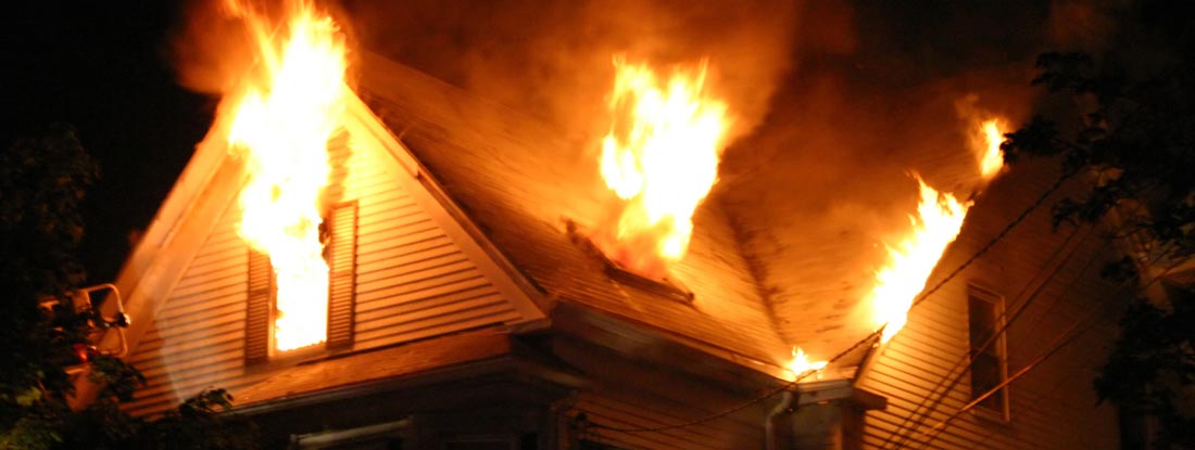 Burning house at night. Find Fire Insurance.