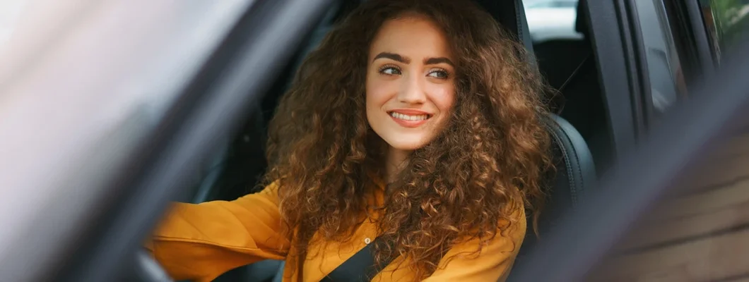 Woman driving a car in the city. Find the Best Car Insurance in Westfield, Indiana at an Affordable Rate. 