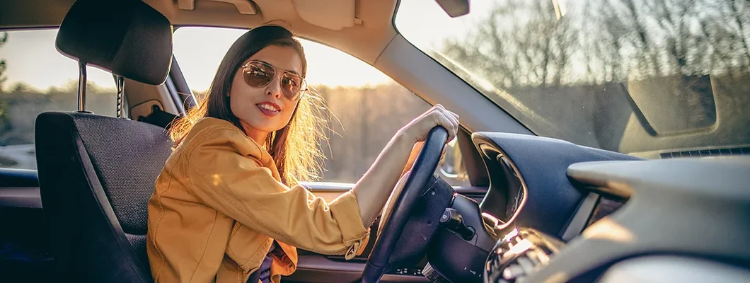 Young woman driving car on a sunny day. How to Find the Best Car Insurance in Narberth, Pennsylvania.
