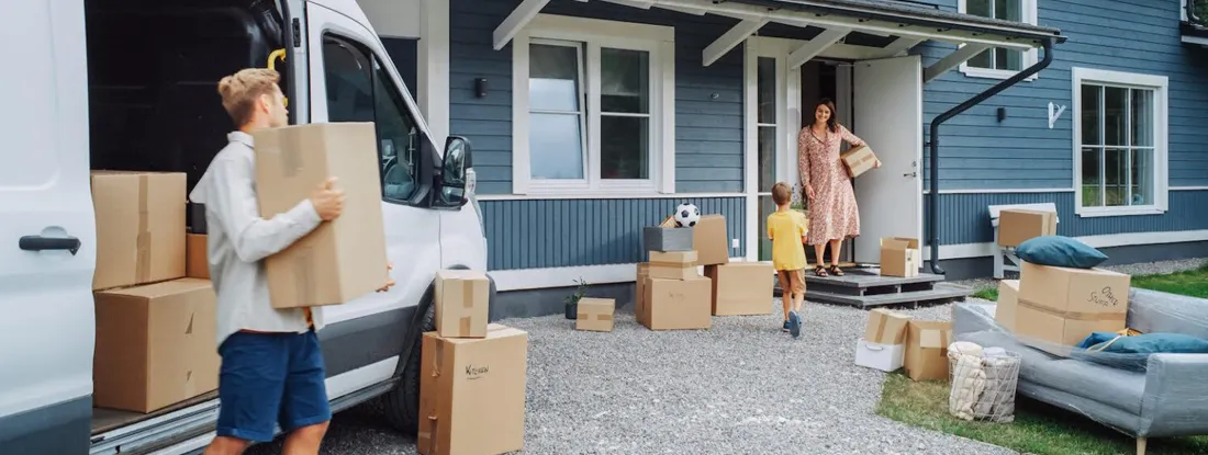 Family Moving to Their New Home in Residential Area. When to Buy a House: How Seasons Affect Home Prices.