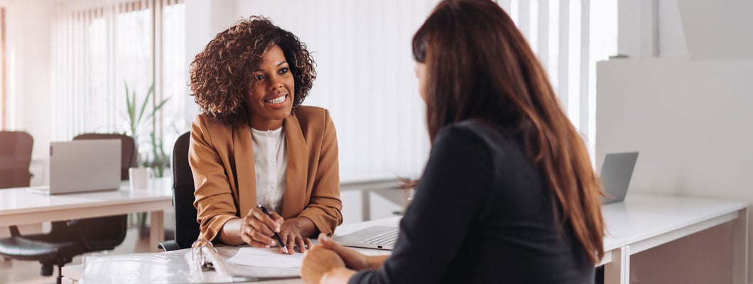 Woman consulting with an independent insurance agent. How to cut insurance costs by a ton.