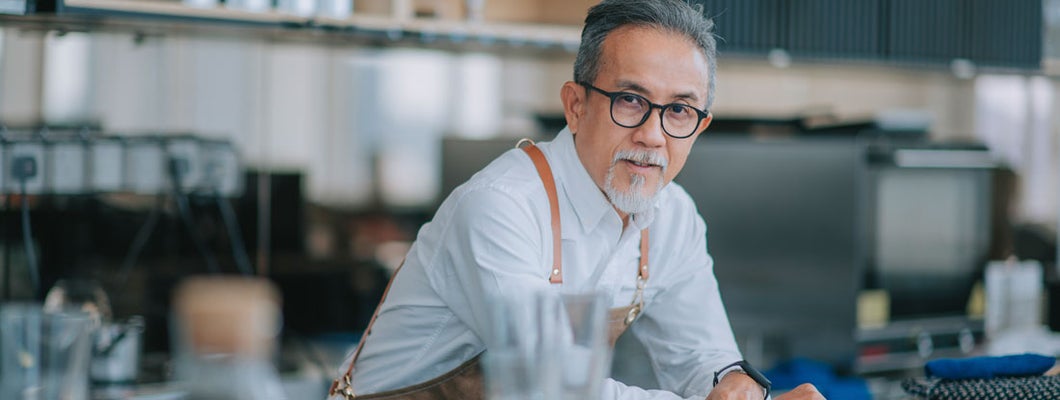 Senior man at commercial kitchen counter. Find Agawam Massachusetts Business Insurance.