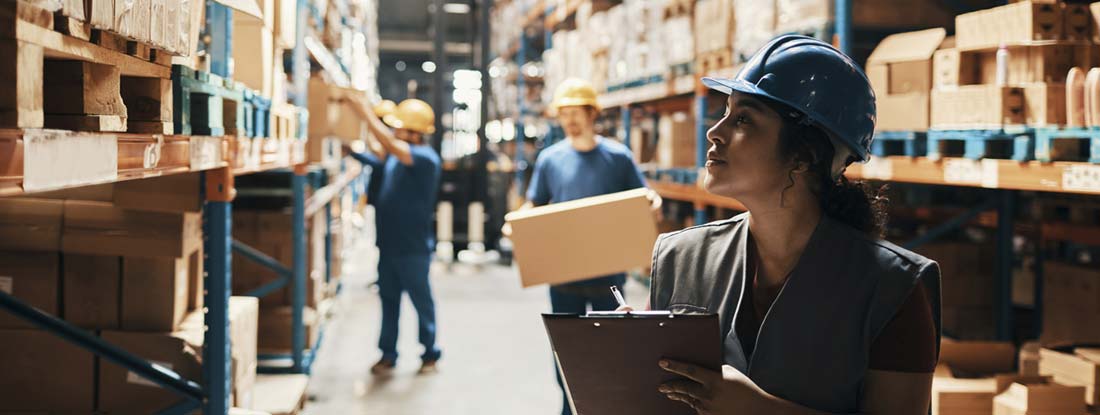 Close up of a group of workers working in a warehouse. How long does voluntary long term disability last?