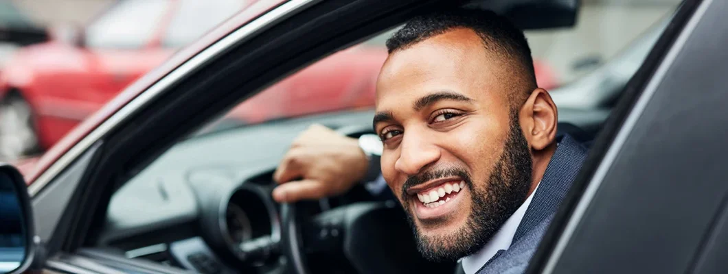 Well dressed man driving a car. Bath, Maine Car Insurance.