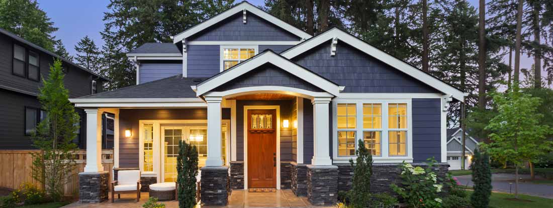Modern residential house with a dark blue exterior. Find Homeowners Insurance.
