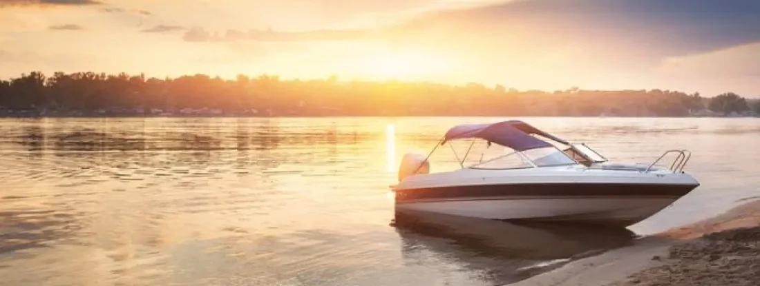 Summer landscape with boat on beach. Find West Virginia Boat Insurance.