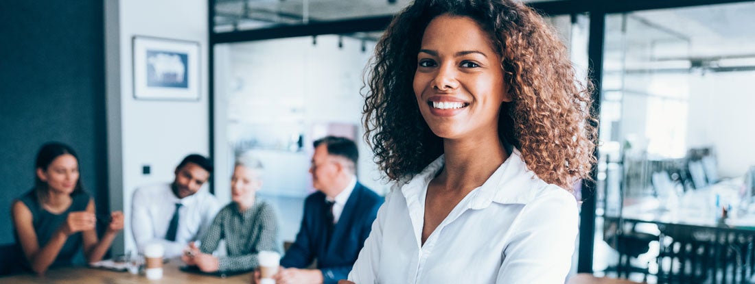 Confident professional standing in a modern office. Florida Errors and Omissions Insurance.