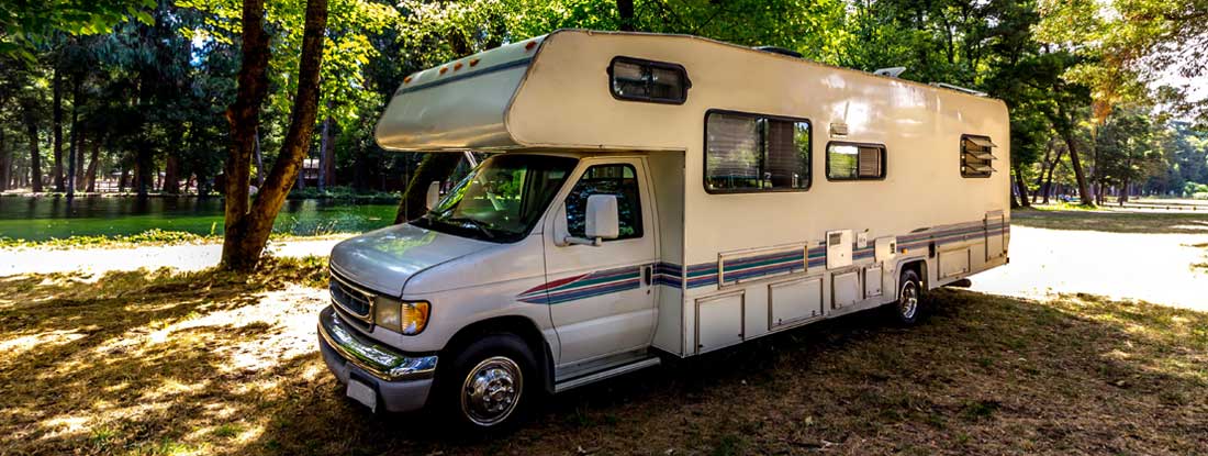Family trip in RV in forest or park in Kansas. Find Kansas RV Insurance.