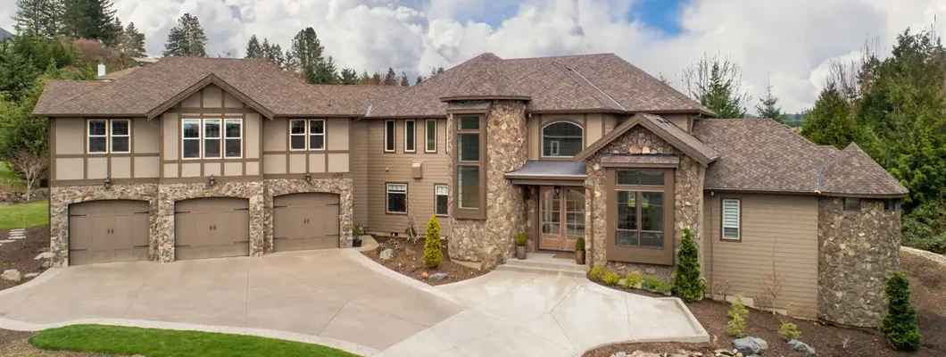 Large luxury home exterior on bright sunny day with blue sky. West Fargo, North Dakota Homeowners Insurance. 