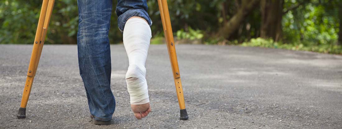 Person using crutches due to a leg injury. Find disability income insurance.