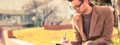 Male college student filling out scholarship applications