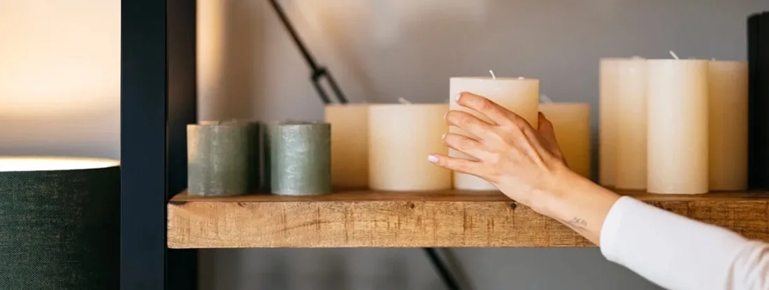 Close Up Photo Of Woman Hands Decorating Her Store. Find Candle Store Business Insurance.