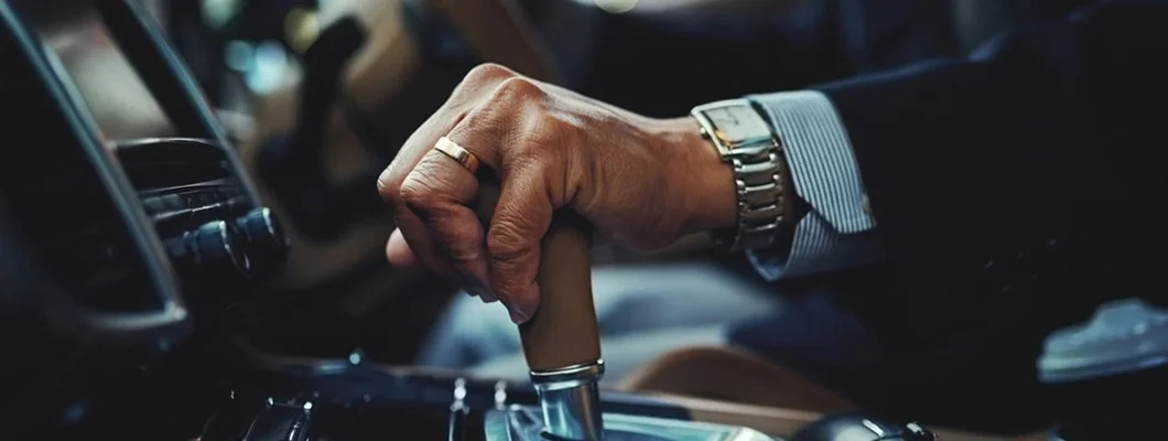 Cropped shot of a businessman changing the gears of a car. Mount Lebanon, Pennsylvania Car Insurance. 
