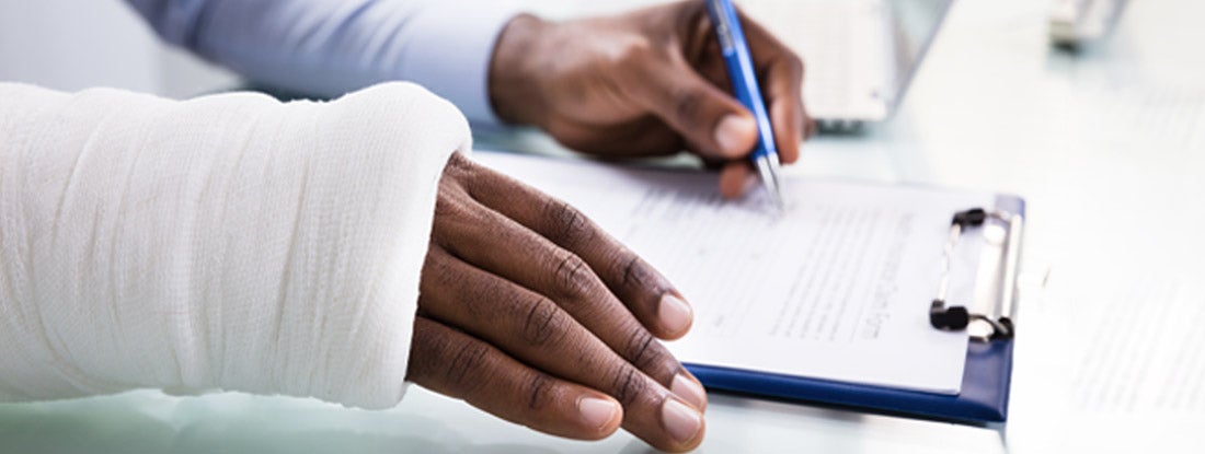 Injured Man reviewing Social Security Disability paperwork. Social Security disability insurance.