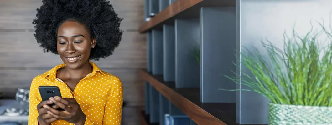 Landlord reading text message on mobile phone. Find New Jersey Landlord Insurance.