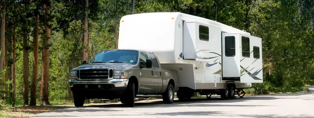 Camper trailer at Yellowstone National Park. Find Conventional Travel Trailer Insurance.
