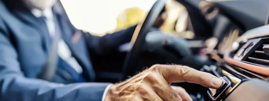 Businessman is sitting in his car and pushing button. How to Great Car Insurance at a Competitive Price in Upper Arlington, OH.