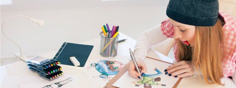 Young female artist painting in art studio.