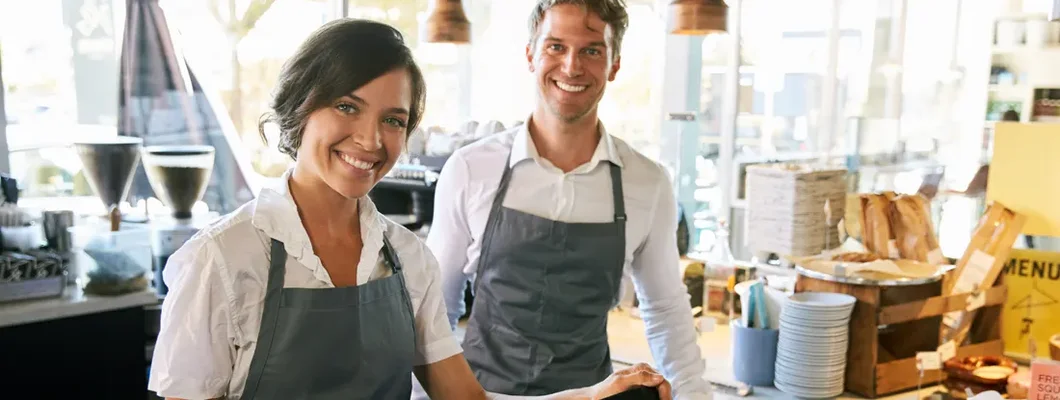 Staff Working At Delicatessen Checkout. Glendale, Arizona Business Insurance. 