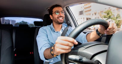 Man driving car. Does Car Insurance Cover the Car or the Driver?