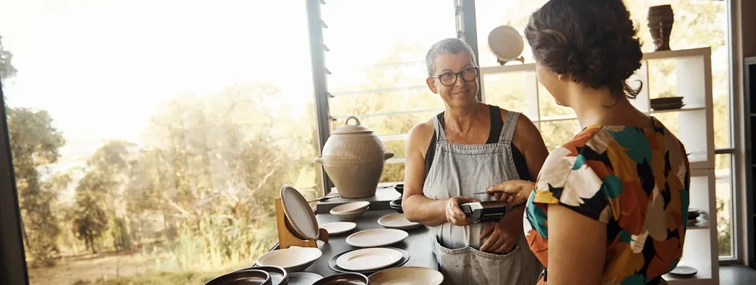 Potter talking to her customer. Jackson, Wyoming Business Insurance. 