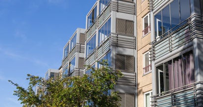 Facade of a modern residential building. Renters insurance cost.