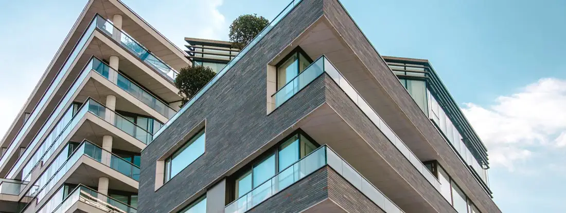 Exterior view of modern condominiums. Find Arkansas condo insurance.