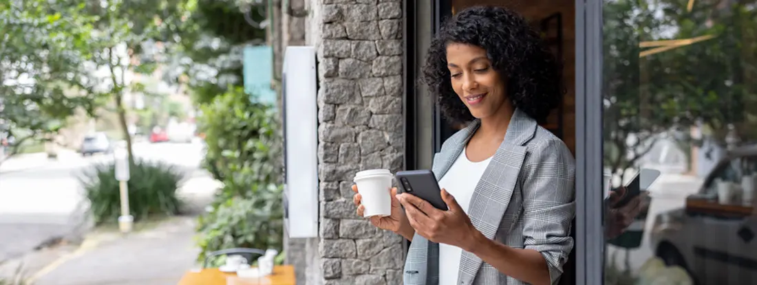 Business owner checking her cell phone. Find Santa Monica, California business insurance.