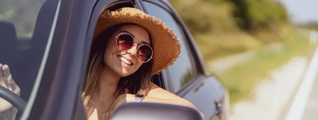 Woman sitting in car and looking through window. Find Mililani Mauka, Hawaii car insurance.