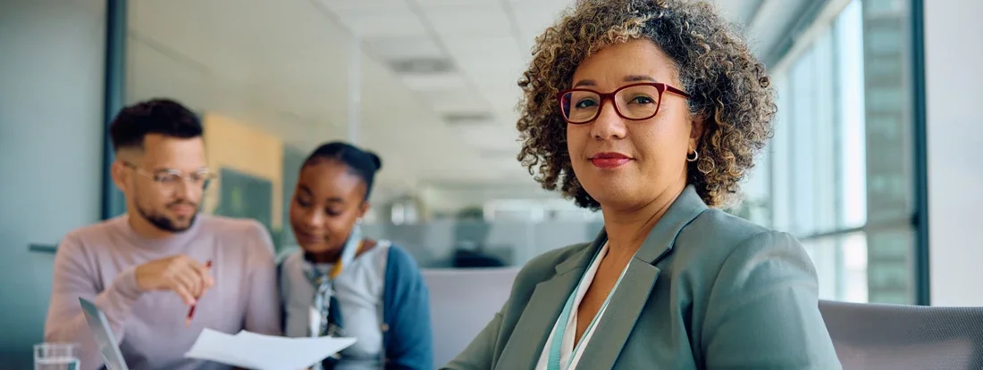 Smiling insurance agent meeting with her clients looking at camera. What Is an Independent Insurance Agent?