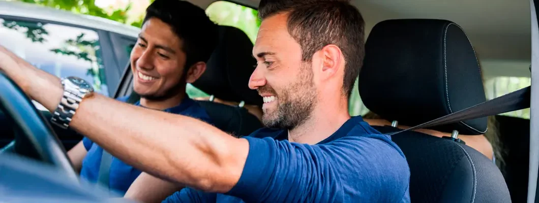 Friends sitting in the car ready to start vacations. Find Bellaire, Texas car insurance.