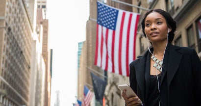 Veteran businesswoman listening to a podcast on her smart phone