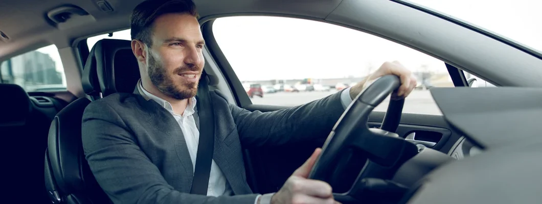Close up photo of a businessman driving a car. How to Find the Best Car Insurance in Potomac, Maryland.