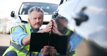 Male Loss Adjuster With Digital Tablet Assessing Insurance Claim. Reasons You Don't Need a Public Insurance Adjuster. 