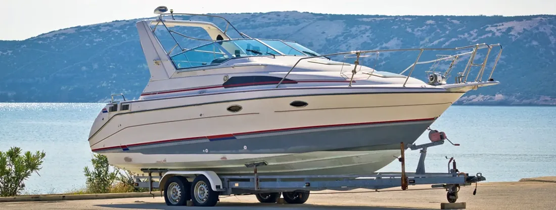 Boat on a trailer by the sea. Find Boat Trailer Insurance.