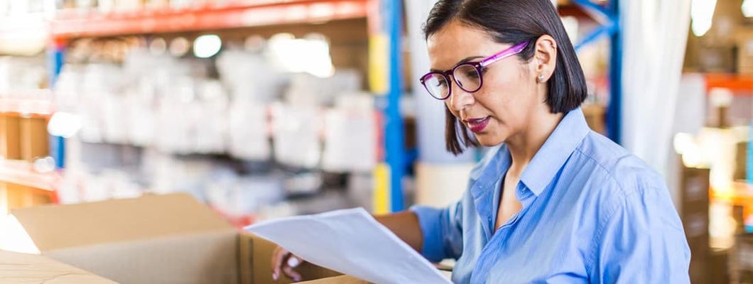 Female businesswoman checking delivery in a small business. Find Lake Mary, Florida business insurance.