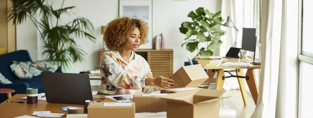 Professional analyzing packaging while sitting at table. Find Bixby, Oklahoma business insurance.