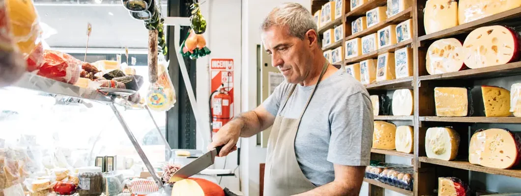 Cheesemonger serving customer orders. Find Parker, Colorado business insurance.